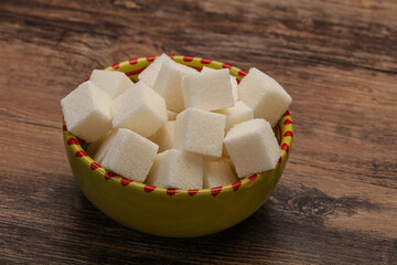 Refined white sugar cubs in the bowl