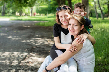 Happy woman because she has children who love her. Mom and children relax together during walks and outdoor games