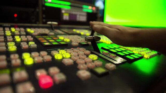 Broadcast Tv Studio Production - Vision Switcher 
Studio Director broadcast video mixer operation - Close-up of hand
