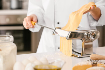 Woman preparing pasta in kitchen, closeup