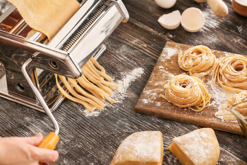 Woman preparing pasta in kitchen