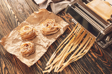 Preparing of pasta with machine on kitchen table