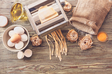 Pasta machine with ingredients on table