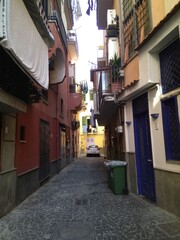 Fototapeta na wymiar The street in Pozzuoli, Italy. The narrowing street conveys the atmosphere of southern Italy well.