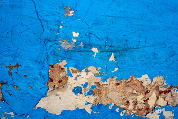 Old dirty shabby green wall with cracks, scratches and peeling paint