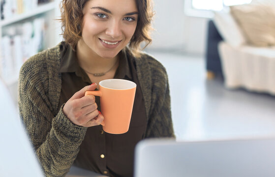 Young woman or student using tablet computer at home