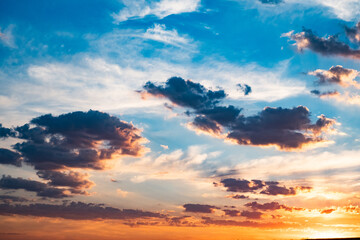 clouds on sky and the orange evening sun setting down