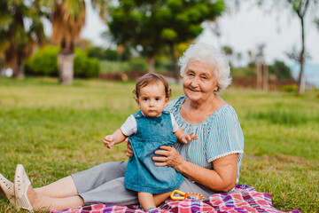 Granddaughter and grandmother in the autumn park