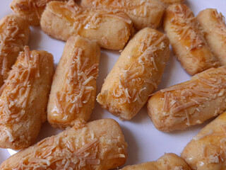 Kaasstengels or Kastengel or Kue Keju, is Dutch influenced-Indonesian cheese cookie in the form of sticks. Isolated in white background