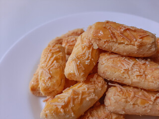 Kaasstengels or Kastengel or Kue Keju, is Dutch influenced-Indonesian cheese cookie in the form of sticks. Isolated in white background