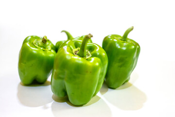 Fresh green capsicum or bell pepper isolated on a white background
