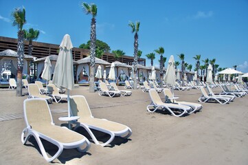 Summer resort with sun beds at the beach 