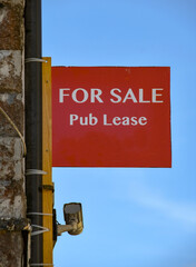 Sign advertising the lease on a public house is for sale