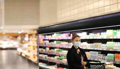 supermarket shopping, face mask and gloves,Woman choosing a dairy products at supermarket			