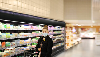 supermarket shopping, face mask and gloves,Woman choosing a dairy products at supermarket			