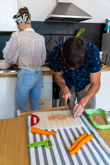 A couple cooking Italian food.