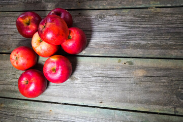 Red apples on wooden background. Copy space.