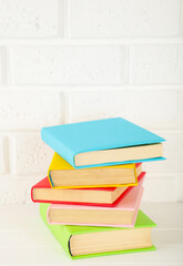 Fototapeta na wymiar Multi coloured school books on a white background with copy space.