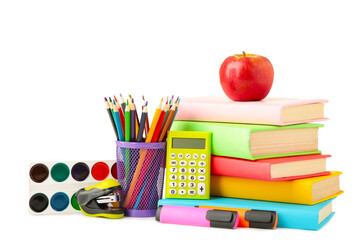 Multi coloured school books and stationery isolated on white background