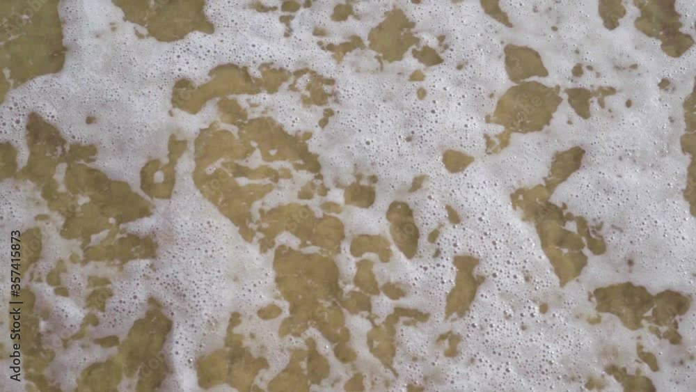 Poster top view of ocean waves with sea foam going back and forth - slow-motion static shot