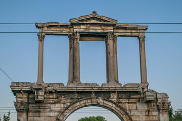 Fototapeta na wymiar Arch-shaped marble-made Hadrian's Arch with Corinthian columns in Athens