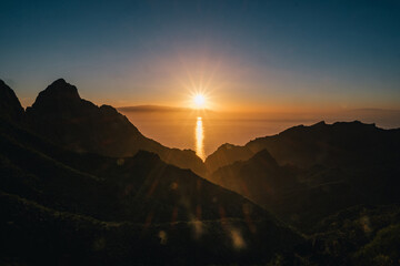 Red sunset over mountains and ocean