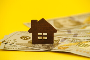 Buying house concept. Legal mortgage. Hose with money on the yellow table