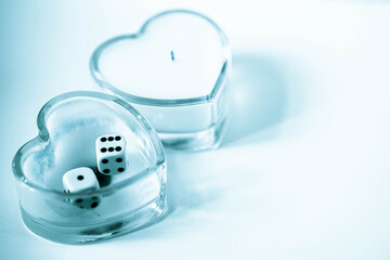 two glass candlesticks in the form of hearts and fortune telling cubes