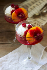 Ice cream, peach and raspberry sauce dessert dedicated to Australian opera singer Melba. Rustic style.