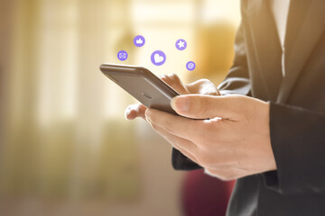 Businessman hands using mobile smartphone with icon social media and network connection. Concept of business or online marketing.