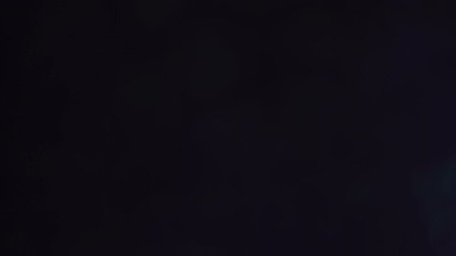 cool bokeh light transition or video overlay, lens flares on dark blue background, 4k footage.