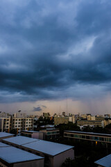 Fototapeta na wymiar Before big rainy cloud sunset sky with city building
