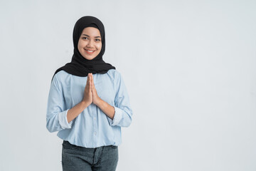 muslim woman smiling with hand showing greeting gesture