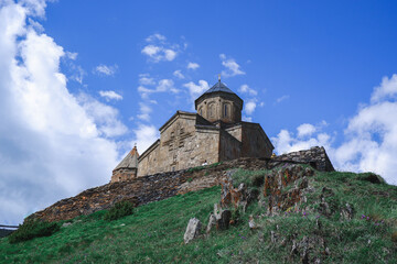 Fototapeta na wymiar Gergeti trinity church. Church at the top of a mountain in Georgia in Kazbegi. Mount Kazbek.