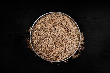 Colored  Anise Spices in a bowl, top view on a dark background, for delicious cooking