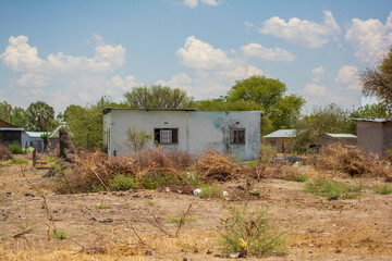 Fototapeta na wymiar Old house with broken windows in Africa abandoned