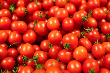 a pile of vegetables red mini tomatoes as background