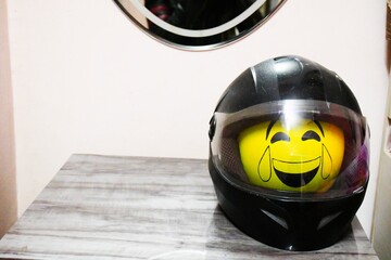 Safety Helmet black color and Emoji Balloon in side of helmet its sow of safety