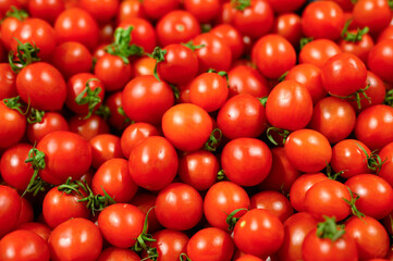a pile of vegetables red mini tomatoes as background