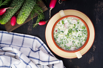 Okroshka. Cold summer soup with yogurt and vegetables in bowl. Top view, overhead, flat lay