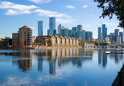 Panorama of Dockland Heritage reflected in the thames River in a sunny day in London