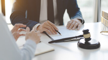 lawyer consulting with client discussing about contract.