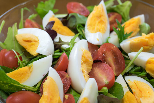 Green salad with boild eggs and tomatoes. 