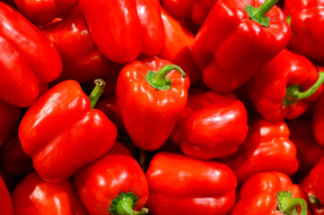a pile of vegetables red sweet bell peppers as background