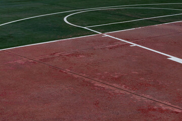 close up empty red and green basketball court floor with white lines. sport theme wallpaper