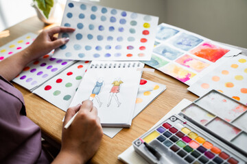 Creative design artist painting colour in art book.