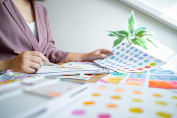 Creative design artist painting colour in art book.