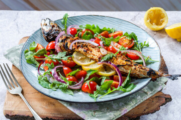Grilled mackerel in spicy coating with fresh salad