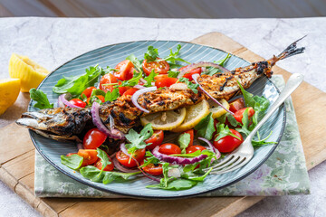 Grilled mackerel in spicy coating with fresh salad