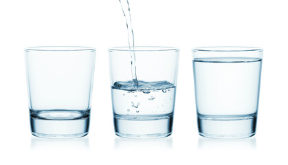 Water is poured into a glass of water. Next to it is an empty and full glass of water. Isolated on...